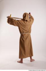 JOEL_ADAMSON WITH CRUCIFIX AND SWORD